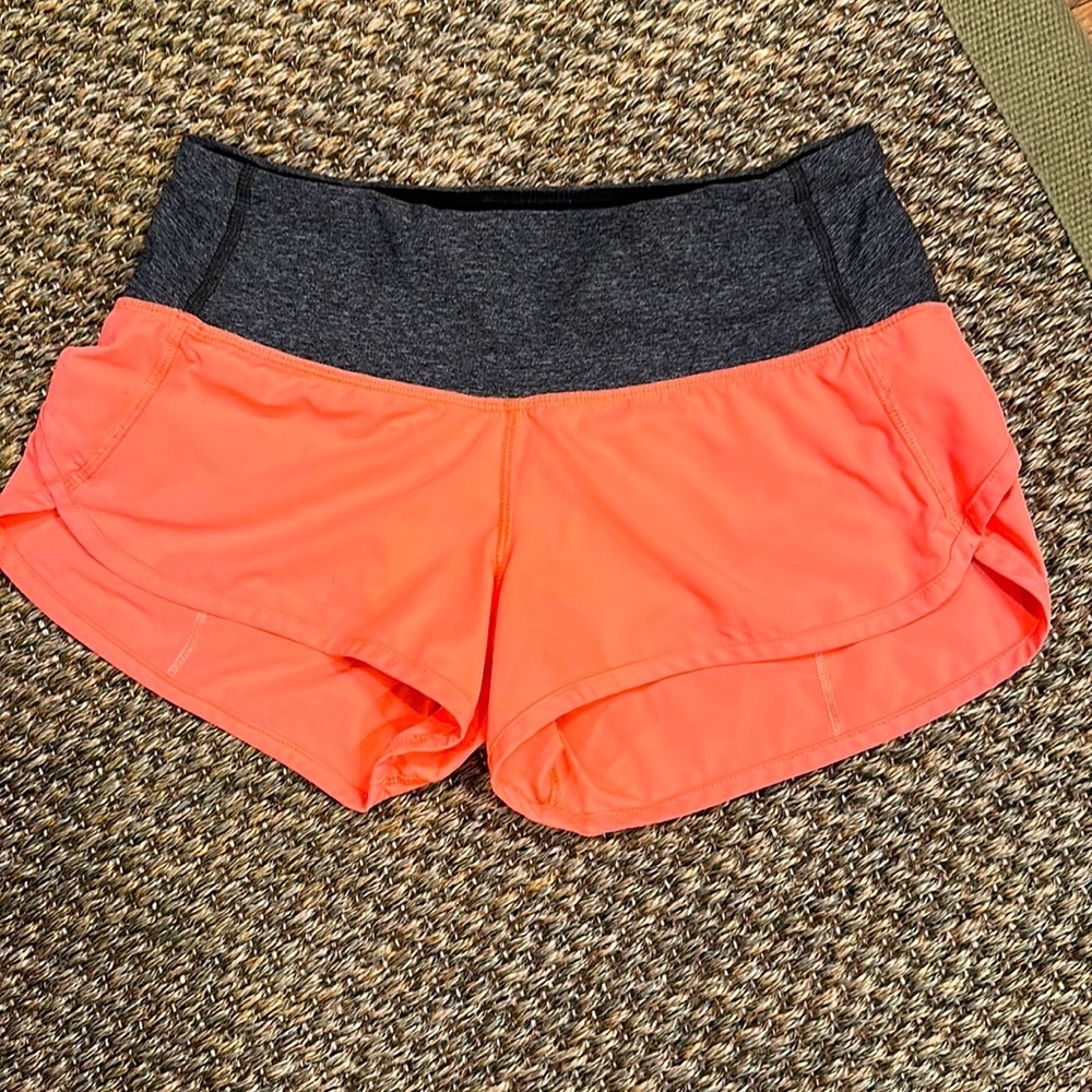 Lululemon shorts; orange and gray; 2.5” inseam; size 2. Very good condition.
